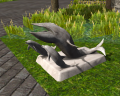 Dolphin and whale statue.png